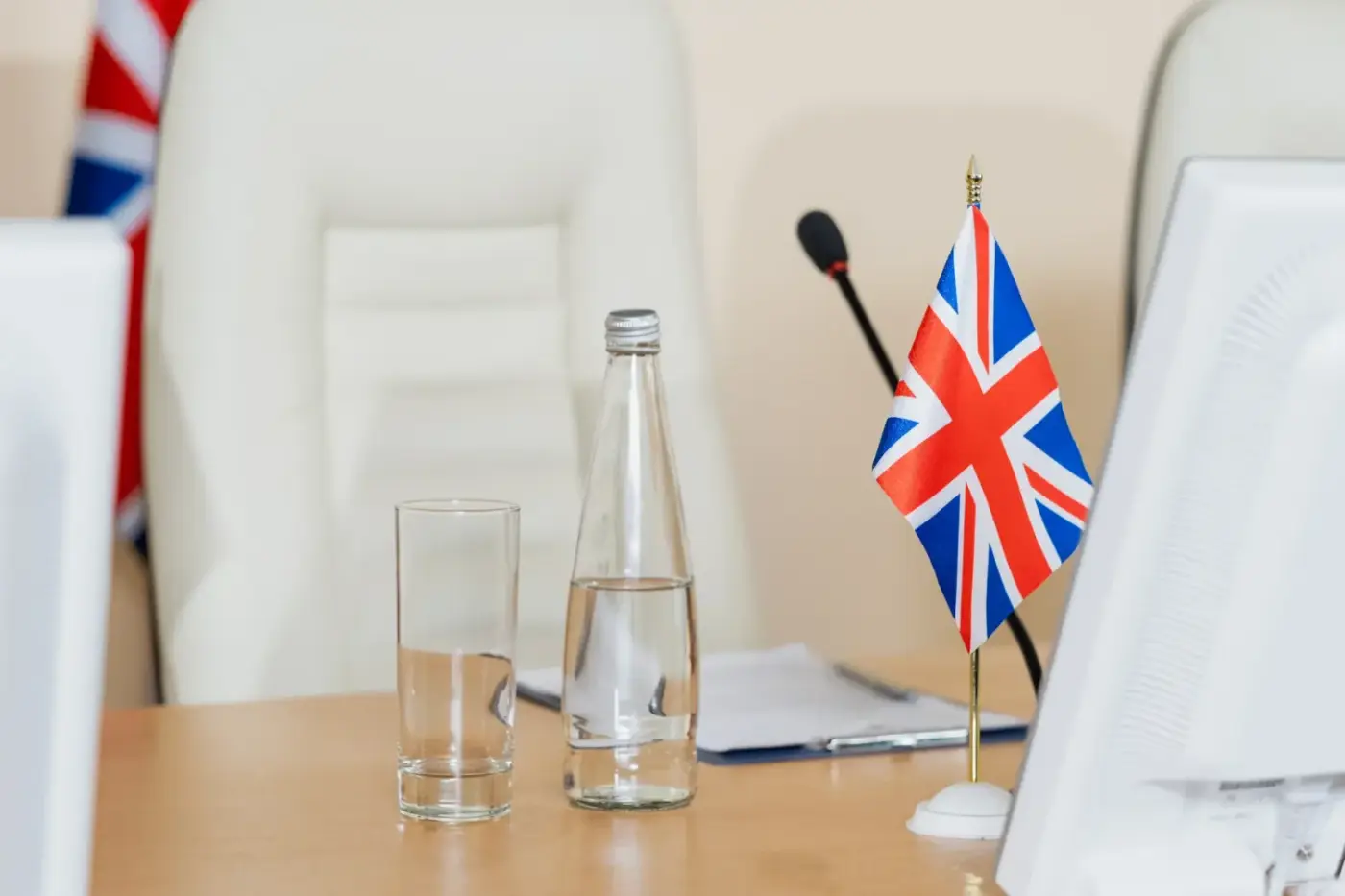 bottle-of-water-glass-and-british-flag-on-workplace